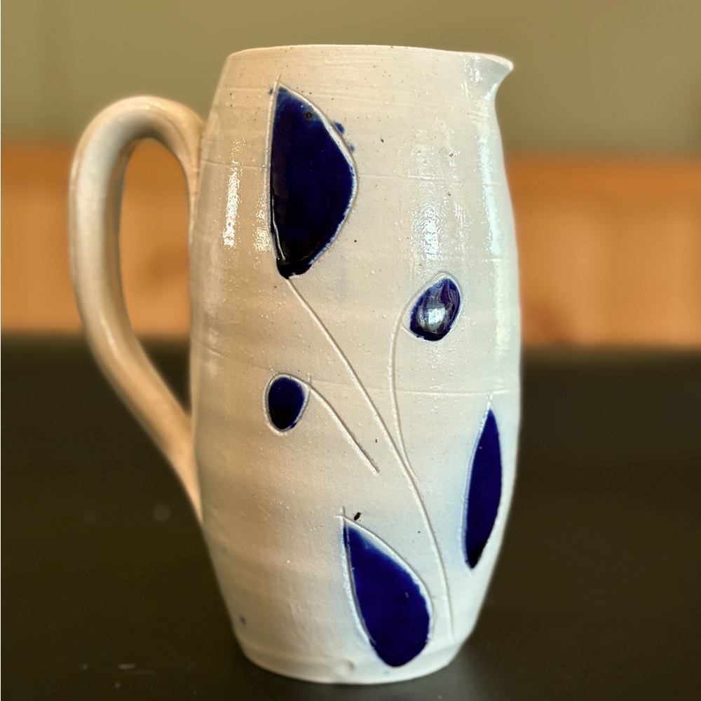 Williamsburg pottery tall water pitcher in blue vine design.